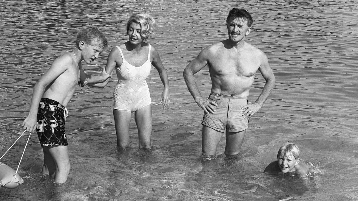 Kirk Douglas his wife Anne and their two children Eric and Peter in Monaco in 1967. (Photo credit should read AFP/AFP via Getty Images)
