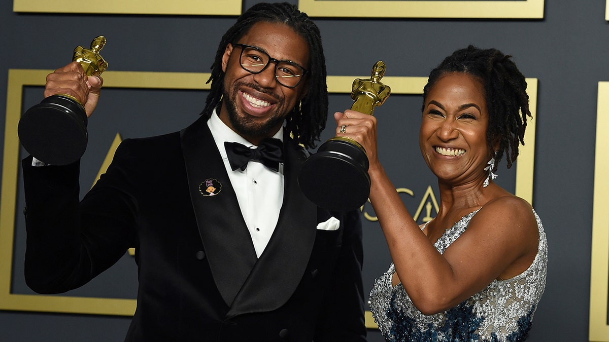 Matthew A. Cherry, left, and Karen Rupert Toliver, winners of the award for best animated short film for "Hair Love", pose in the press room at the Oscars on Sunday, Feb. 9, 2020, at the Dolby Theatre in Los Angeles. (Photo by Jordan Strauss/Invision/AP)
