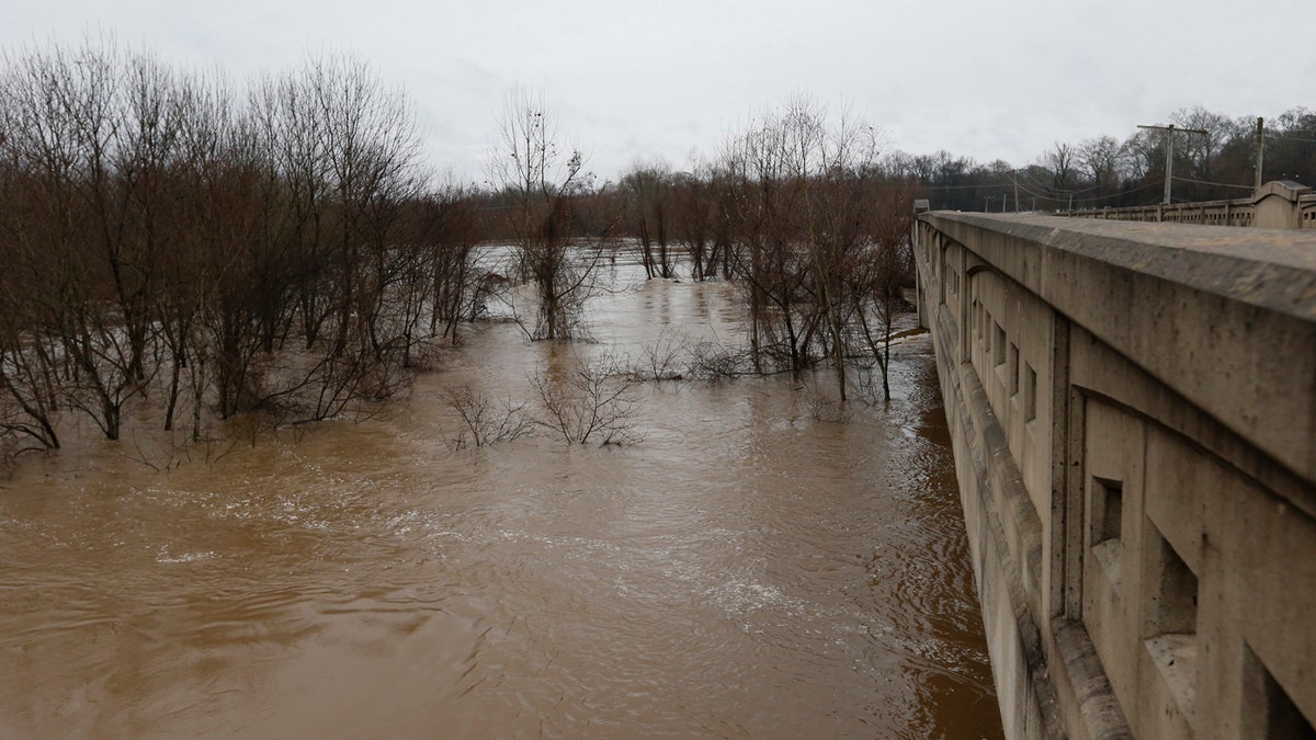 Strong currents from the swollen Pearl River push past the Old Brandon Road Bridge in Jackson, Miss., Sunday, Feb. 16, 2020.