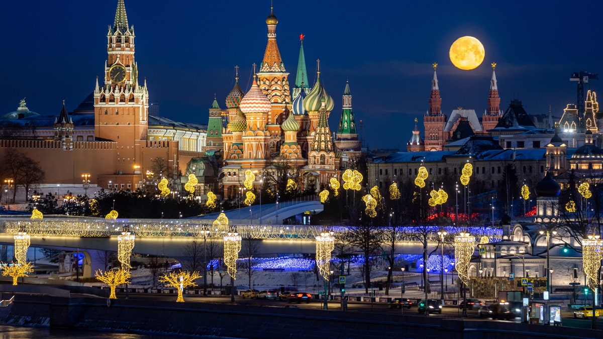 The full moon lights up the sky over the Moscow Kremlin waterfront, Spasskaya Tower, St Basil's Cathedral, on Feb. 8, 2020.