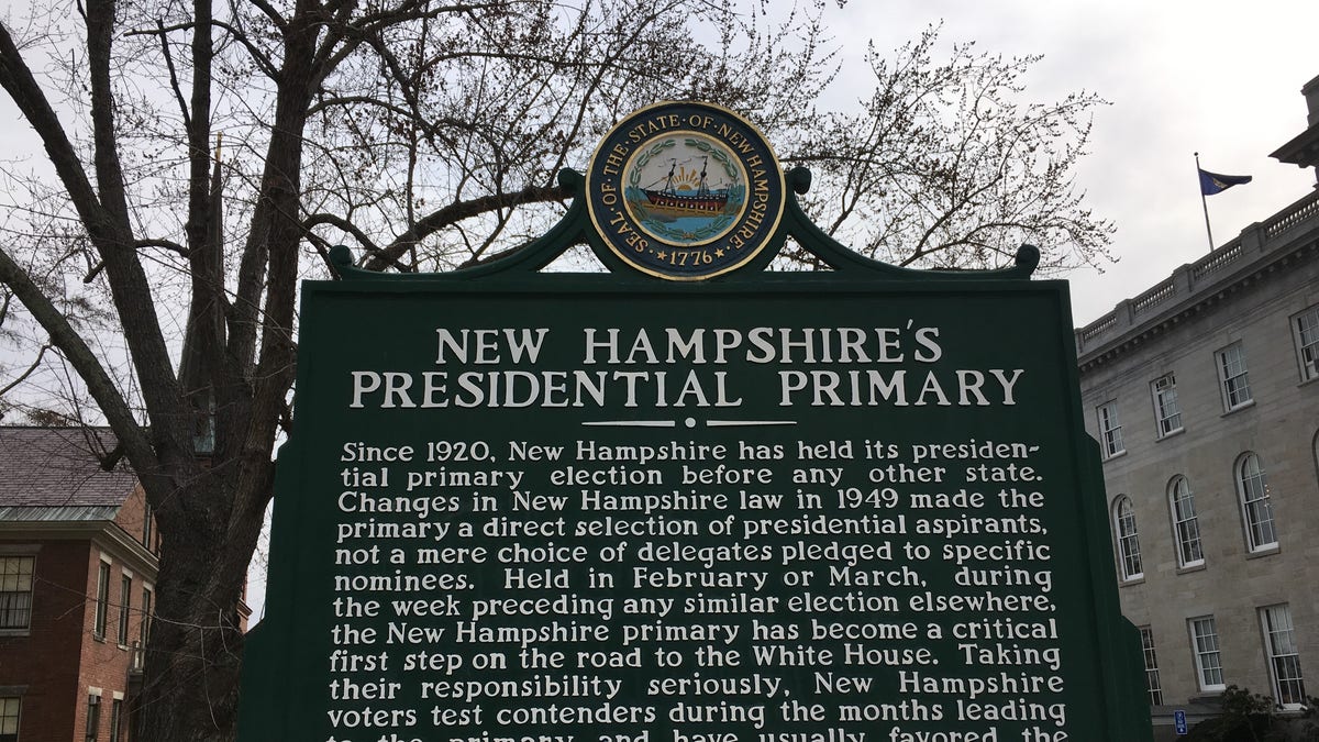 A sign next to the Statehouse in Concord, NH highlights that New Hampshire's held the first-in-the-nation presidential primary for 100 years