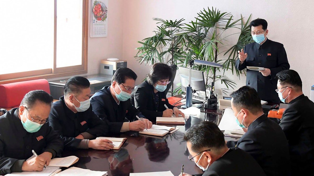 In this photo distributed on Feb. 12, by the North Korean government, North Korean Premier Kim Jae Ryon, right top, has a meeting at the emergency anti-epidemic headquarter in Pyongyang, North Korea. (Korean Central News Agency/Korea News Service via AP)