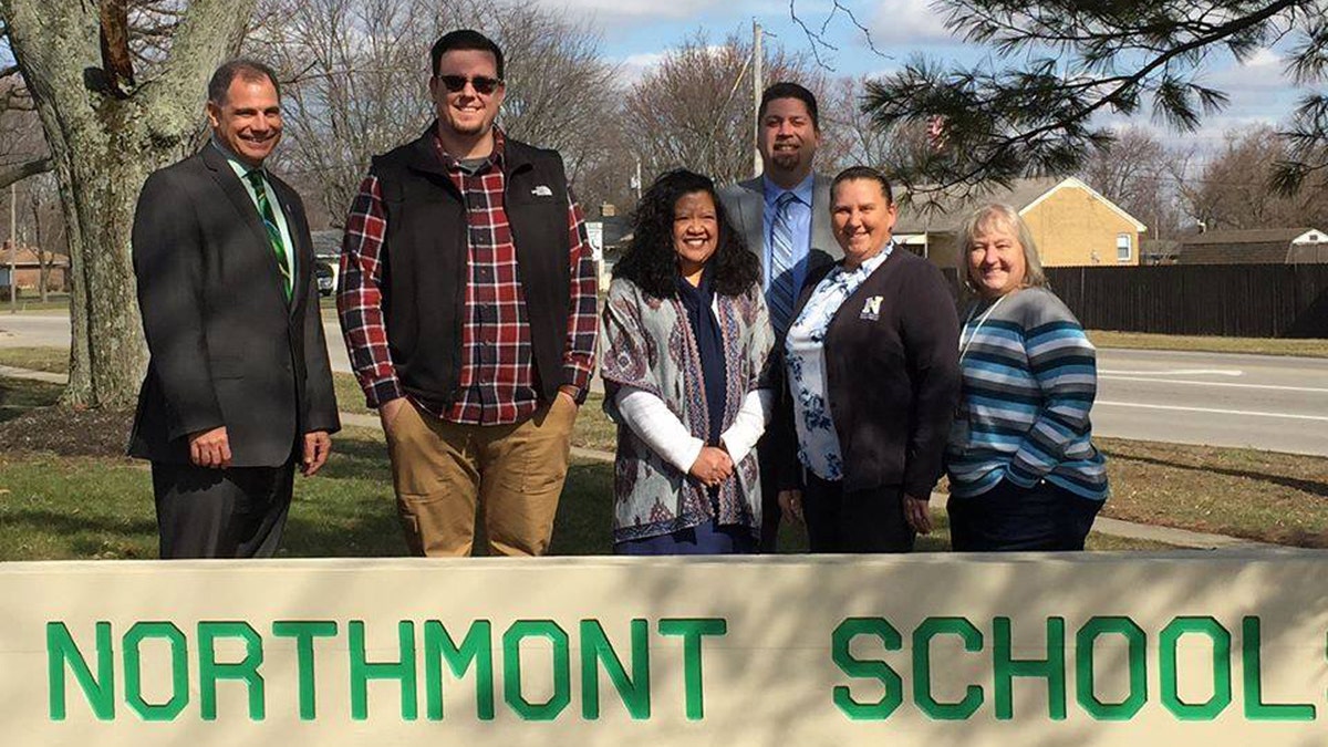 Bob Hawker, the Next Steps pastor at Salem Church of God, is pictured in the vest with the staff at Northmont School. The church helped pay off thousands of dollars in student lunch debt.