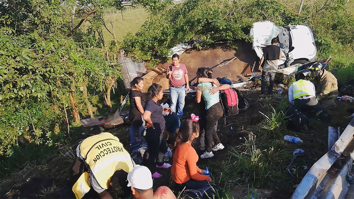 Migrants are treated by first responders following a crash on a highway in San Andres Tuxtla, Veracruz state, Mexico on Tuesday. (Tamara Corro/Reuters TV via REUTERS)