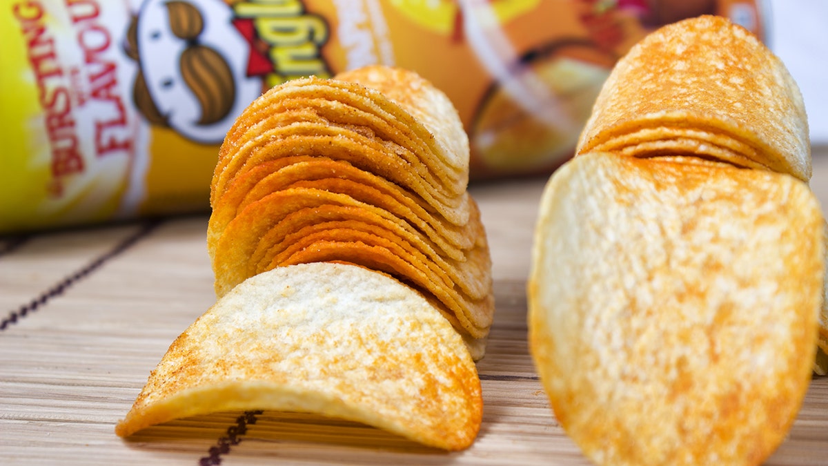 Milan, Italy - April 24, 2013: Pringles potato chips in front of snack size Pringles can. Pringles was invented by Procter and Gamble but in April Procter and Gamble agreed to sell the Pringles brand to Diamond Foods of California.