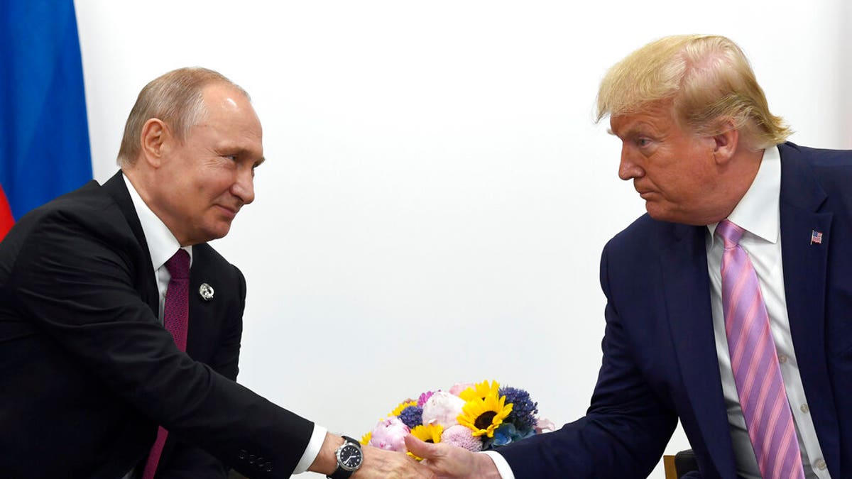 Trump and Putin handshake