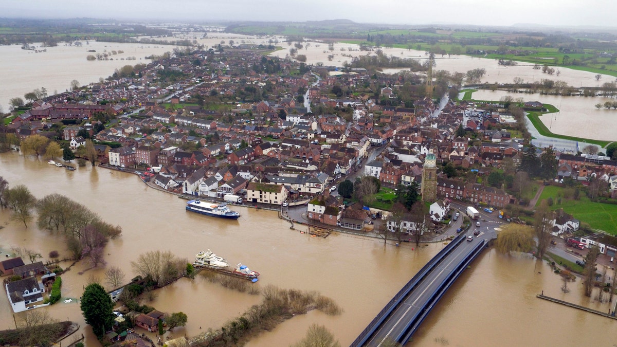 Floodwater surrounds the town of Upton-upon-Severn, England, with the normal course of the river Severn running horizontally under the road bridge, in the aftermath of Storm Dennis, in this photo taken with a drone Thursday, Feb. 20, 2020.