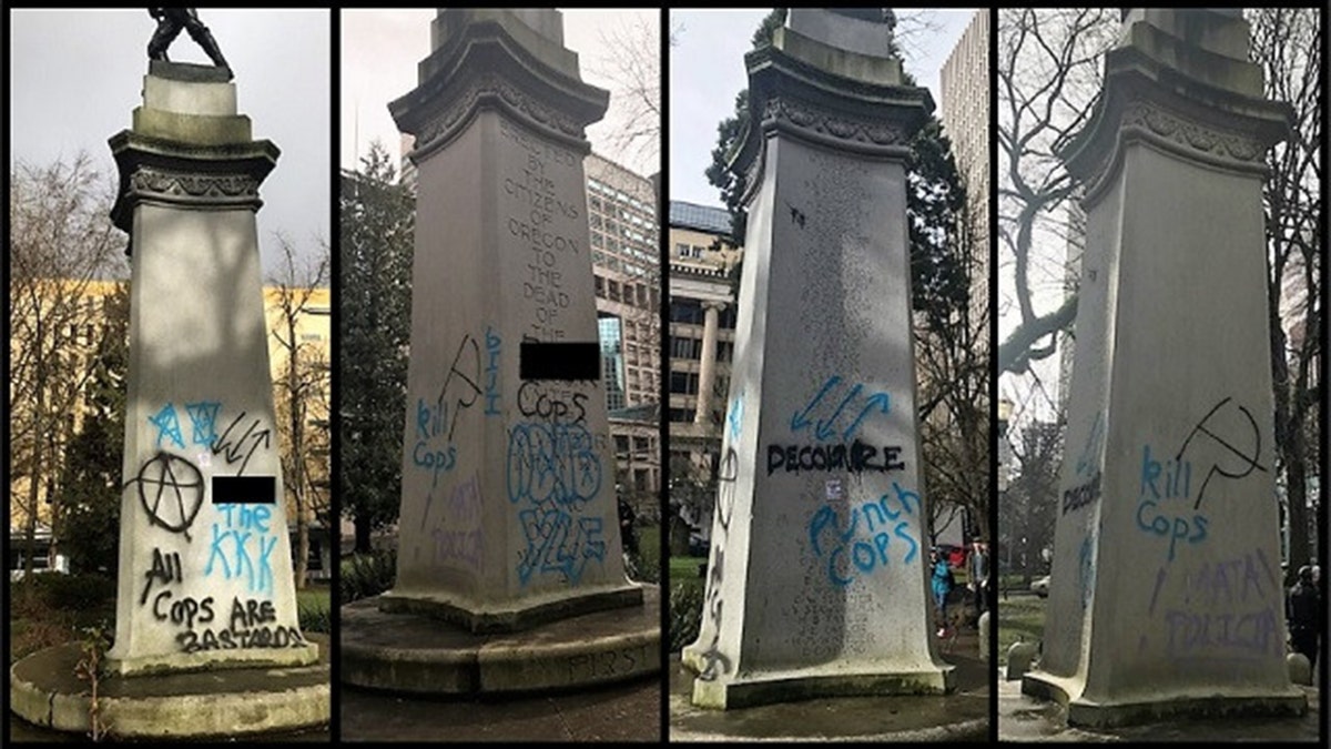 Messages can be seen spray-painted on a war memorial in Portland, Ore. after a demonstration on Saturday.