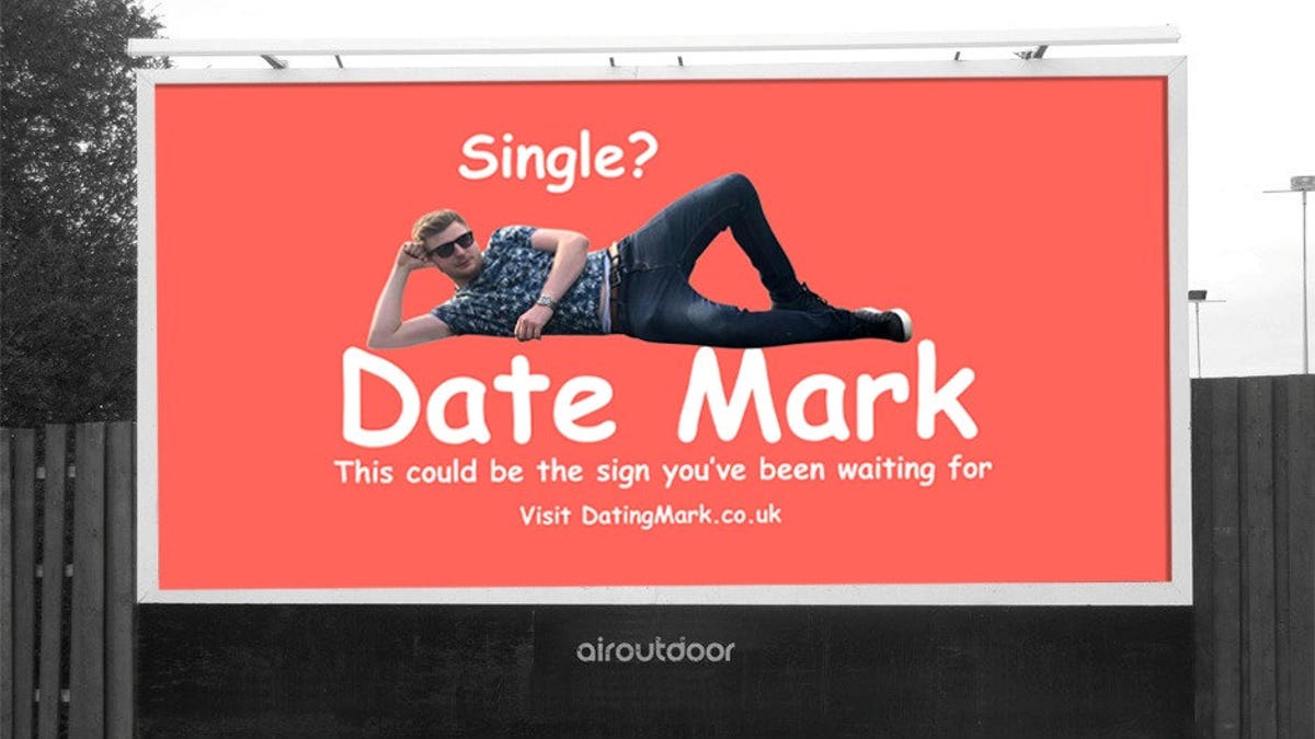 "Single? Date Mark. This could be the sign you've been waiting for,” the neon sign reads, featuring the bachelor in a playful pose.