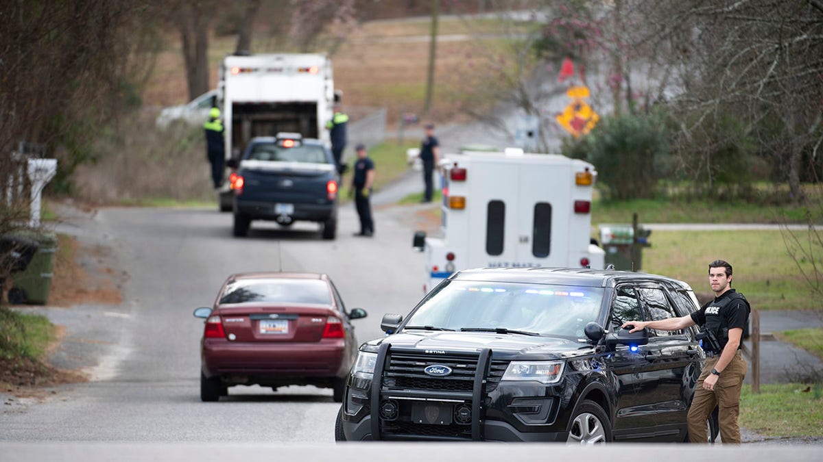 A Cayce police officer blocked an entrance to the Churchill Heights neighborhood on Thursday as investigators continued to search for Faye. (AP Photo/Sean Rayford)