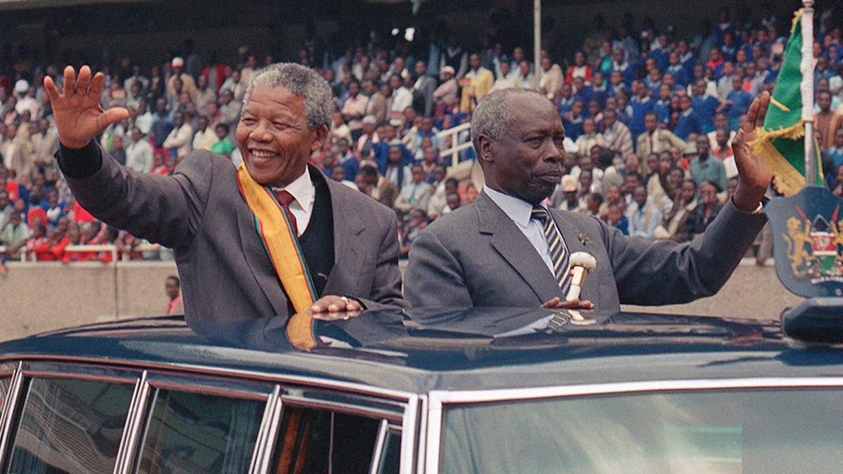 South African leader Nelson Mandela, left, and Kenya President Daniel arap Moi wave to the crowd at a public rally for the African National Congress in Nairobi, Kenya, in 1993. (AP)