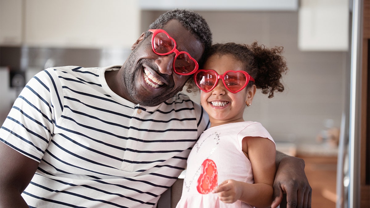 Dad and daughter with heart sunglasses