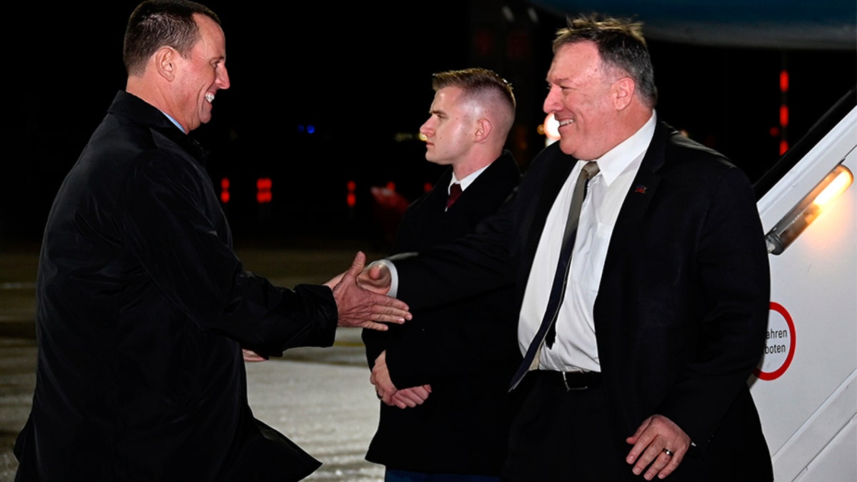 Secretary of State Mike Pompeo is greeted by U.S. ambassador to Germany Richard Grenell as he arrives at Munich International Airport, in Munich, Germany on Thursday, Feb. 13, 2020.