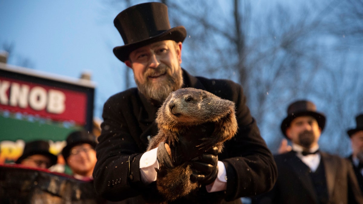 Dereume holds Punxsutawney Phil during the 134th celebration of Groundhog Day on Gobbler's Knob in Punxsutawney, Pennsylvania