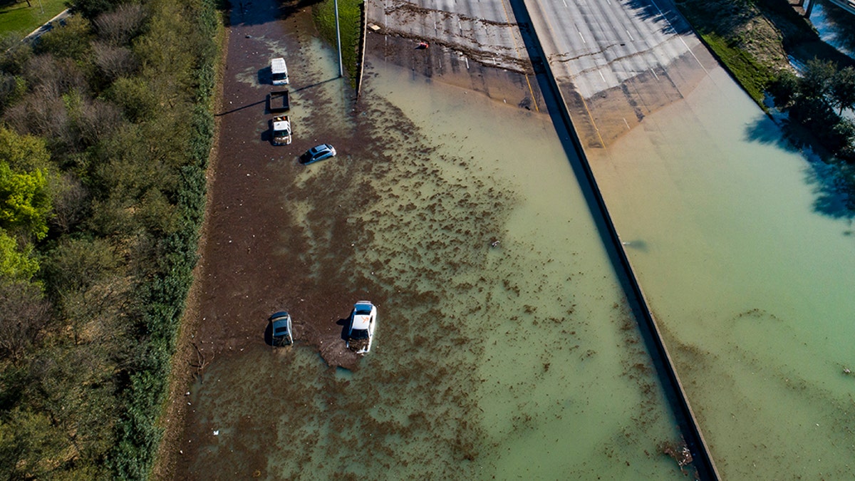 In this aerial photo, water is slowly draining from the freeway after a water main break east of the location flooded all lanes, closing the freeway in both directions, at the intersection of 610 and Clinton Drive, Thursday, Feb. 27, 2020. (Associated Press)