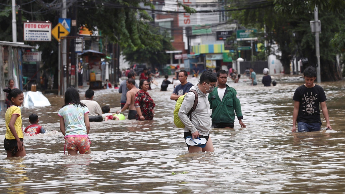 Overnight rains caused rivers to burst their banks in greater Jakarta sending muddy water into residential and commercial areas, inundating thousands of homes and paralyzing parts of the city's transport networks, officials said.