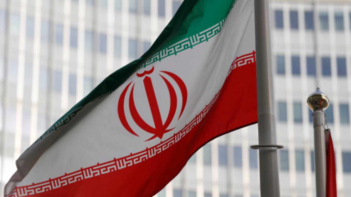 The Iranian flag flutters in front of the International Atomic Energy Agency (IAEA) headquarters in Vienna, Austria. 