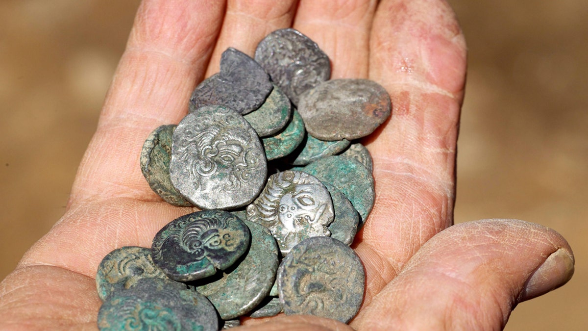 A bumper Iron Age coin hoard has been officially recognized as a Guinness World Record for the largest ever of its kind recovered in the British Isles. (Credit: SWNS)
