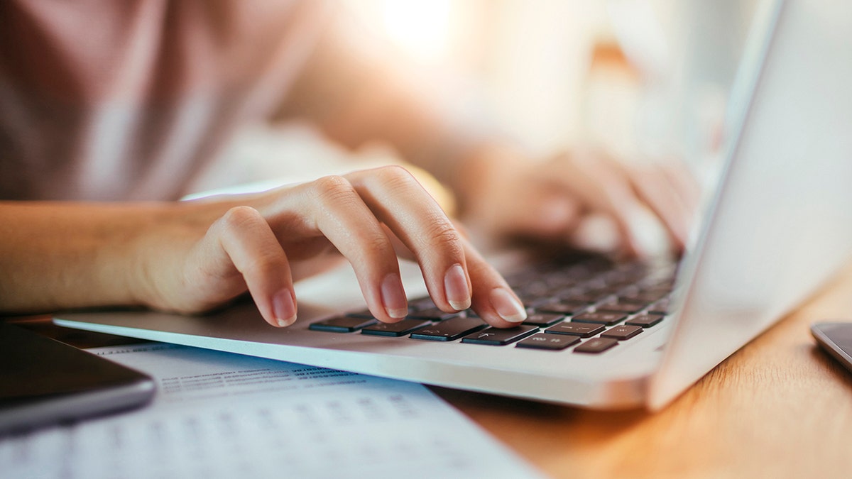 Person typing on laptop