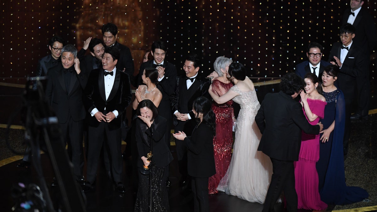 'Parasite' cast and crew members accept the award for best picture.