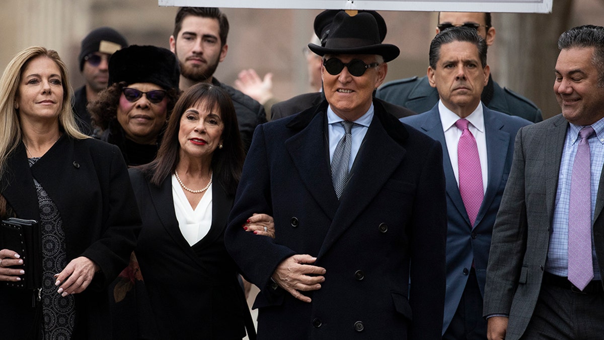 Roger Stone accompanied by his wife Nydia Stone, second from left, arrives for his sentencing at federal court in Washington, Thursday, Feb. 20, 2020. Roger Stone, a staunch ally of President Donald Trump, faces sentencing on his convictions for witness tampering and lying to Congress. (AP Photo/Manuel Balce Ceneta)