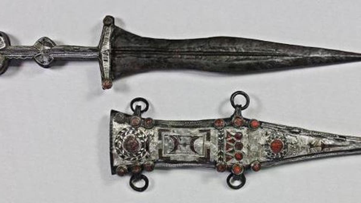 The restorer was able to remove the dagger from its sheath.