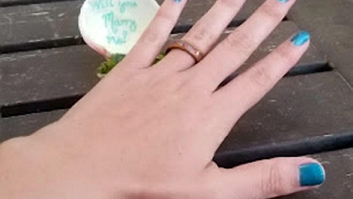 Thoughtfully, Studenic had sea glass saved from their first Bonaire trip crushed and embedded into the engagement ring.