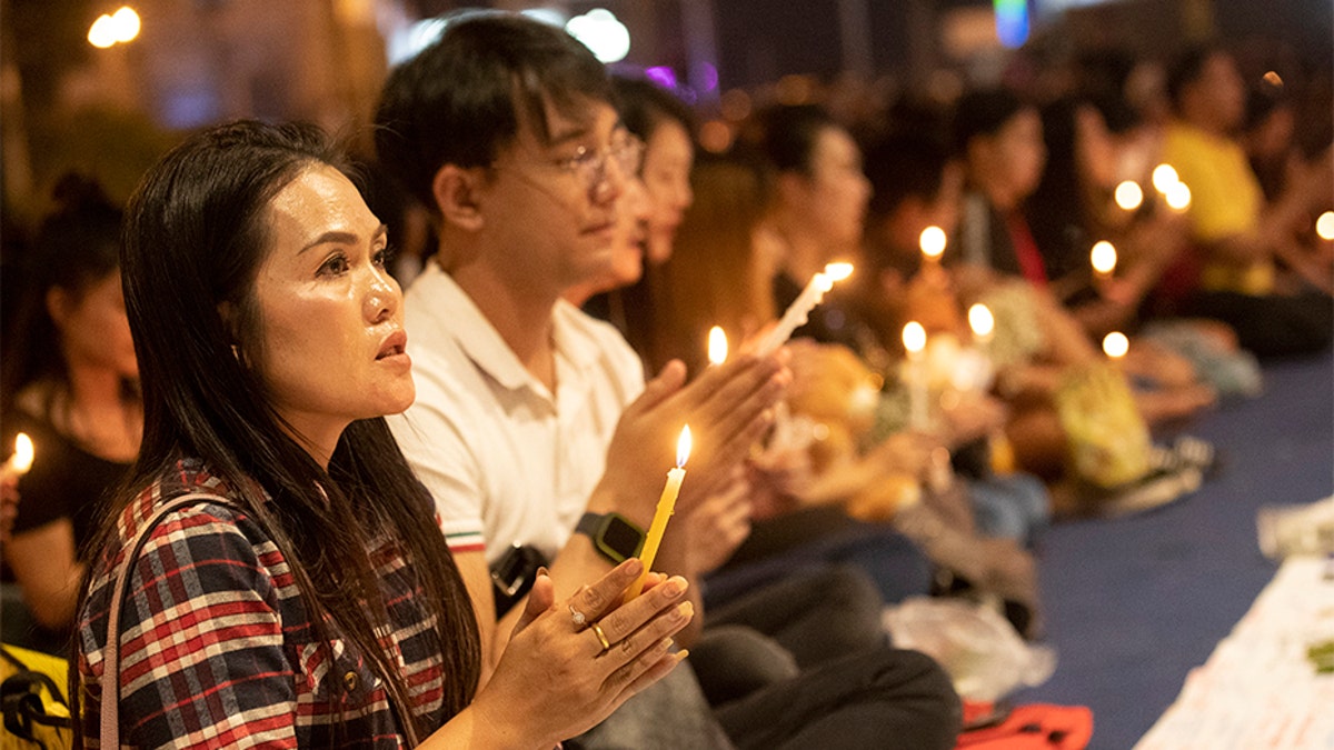 People attend a memorial service at the Terminal 21 Korat shopping mall in Nakhon Ratchasima, Thailand, on Monday. (AP)