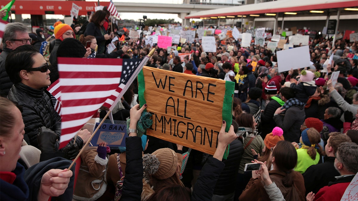 Demonstrators yell slogans during an anti-Donald Trump travel ban protest outside Hatfield-Jackson Atlanta International Airport