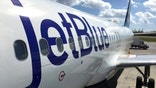 George Town, Cayman Islands - December 21, 2017: Land operations and boarding in Owen Roberts Intl. Airport in Grand Cayman Islands. Close up of a JetBlue plane in a sunny day.