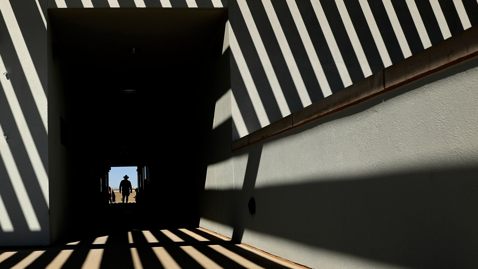 An usher walks along an upper deck concourse before a spring training baseball game between the Cleveland Indians and the San Diego Padres in Peoria, Arizona, Feb. 26, 2020.