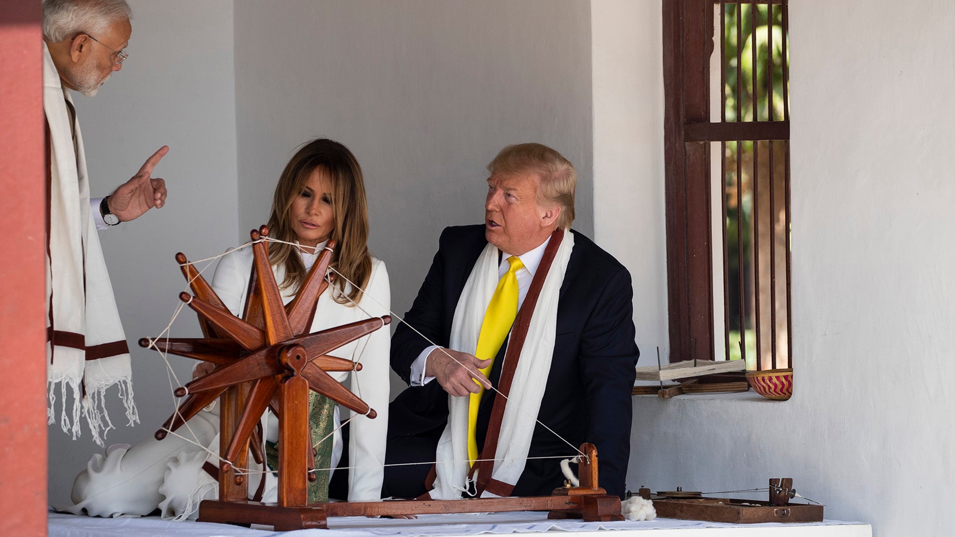 President Donald Trump, with first lady Melania Trump, and Indian Prime Minister Narendra Modi, look at a Charkha, or a spinning wheel, during a tour of Gandhi Ashram, in Ahmedabad.