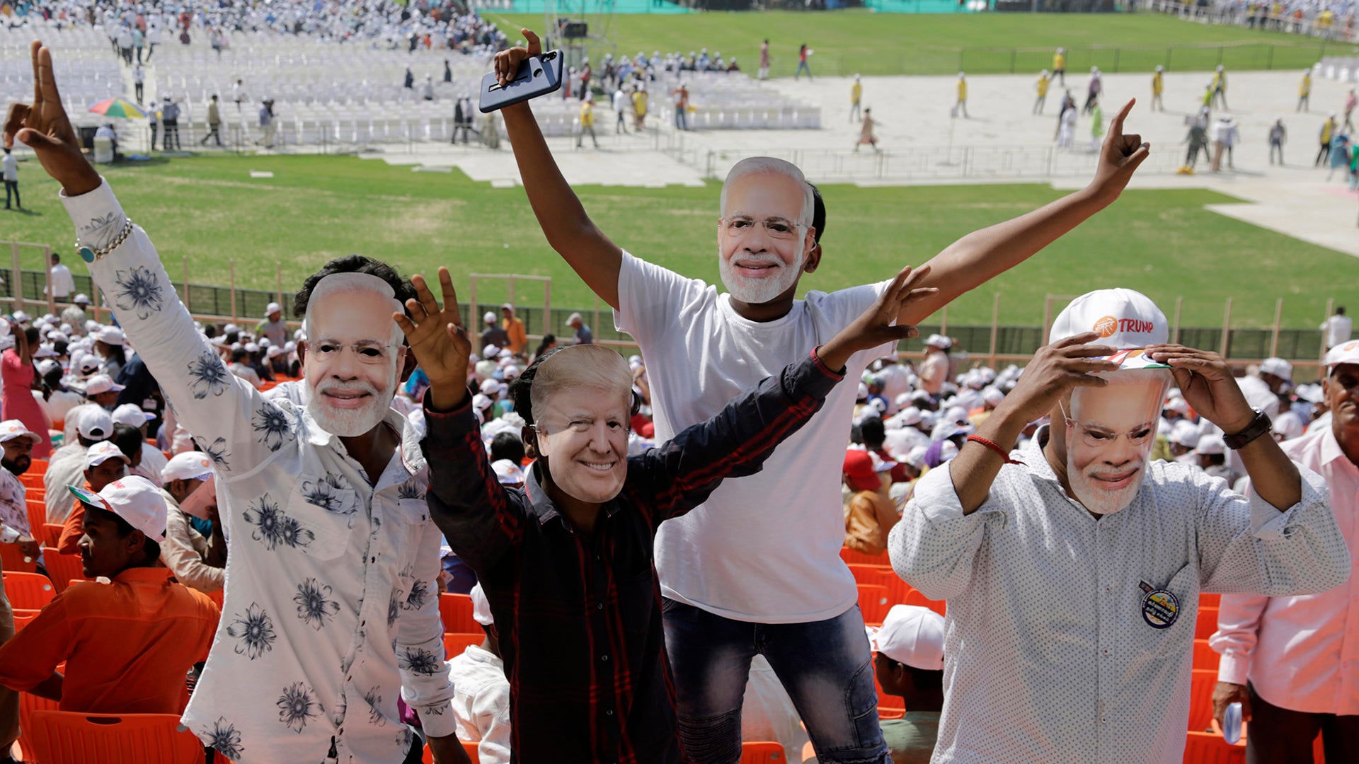 Indians wear masks of President Trump and Indian Prime Minister Narendra Modi While attending the Namaste Trump event at Sardar Patel Stadium in Ahmedabad, India.