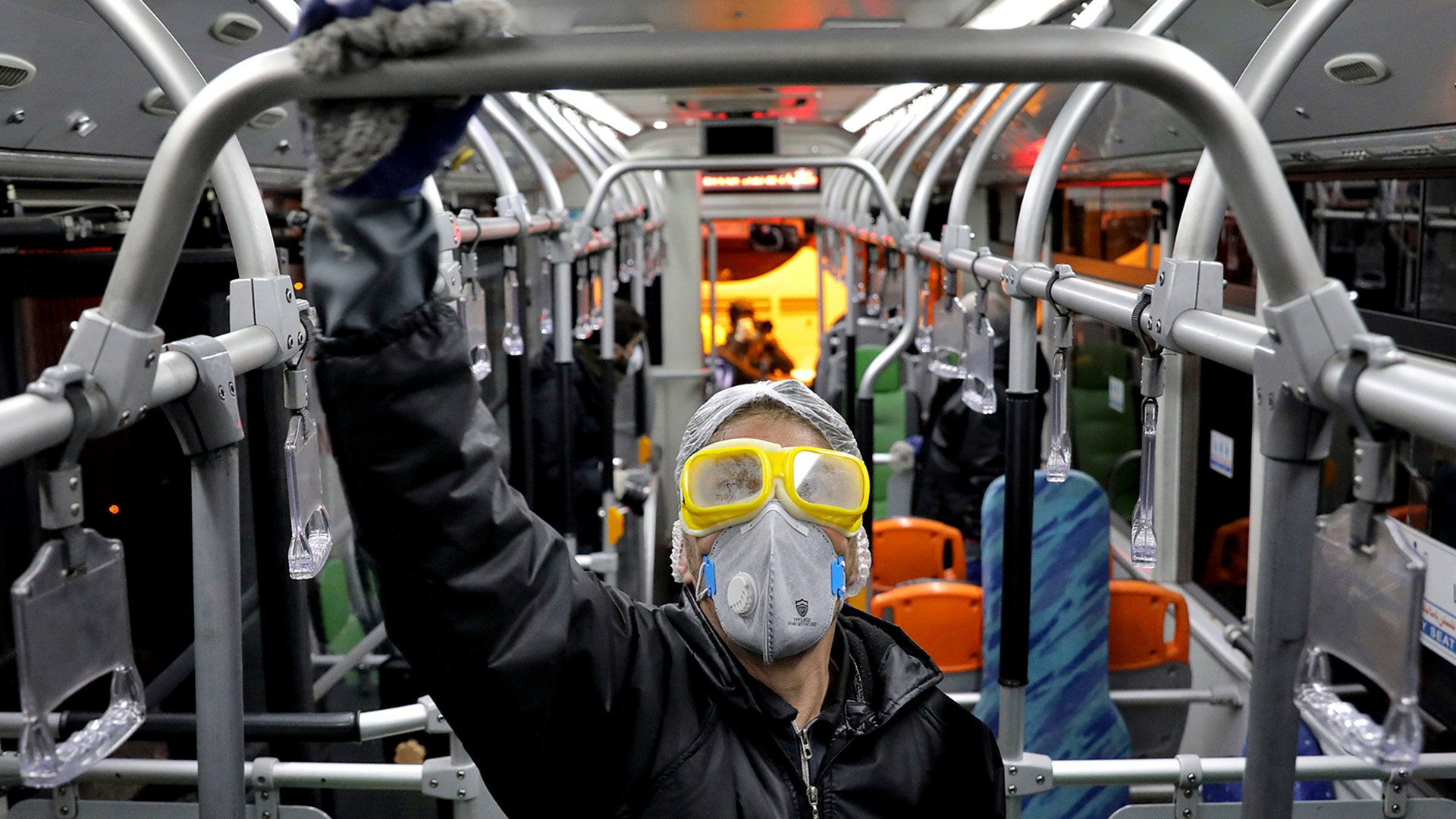 A worker disinfects a public bus against coronavirus in Tehran, Iran, Feb. 26, 2020. 