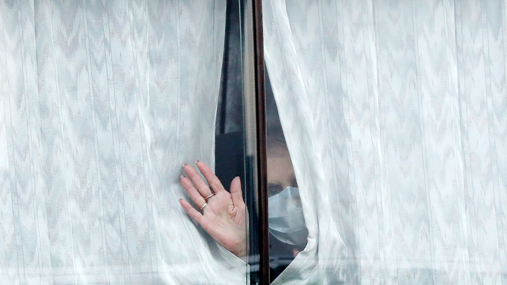 A bus carrying passengers from the quarantined Diamond Princess cruise ship leaves a port in Yokohama, Japan, Feb. 20, 2020.