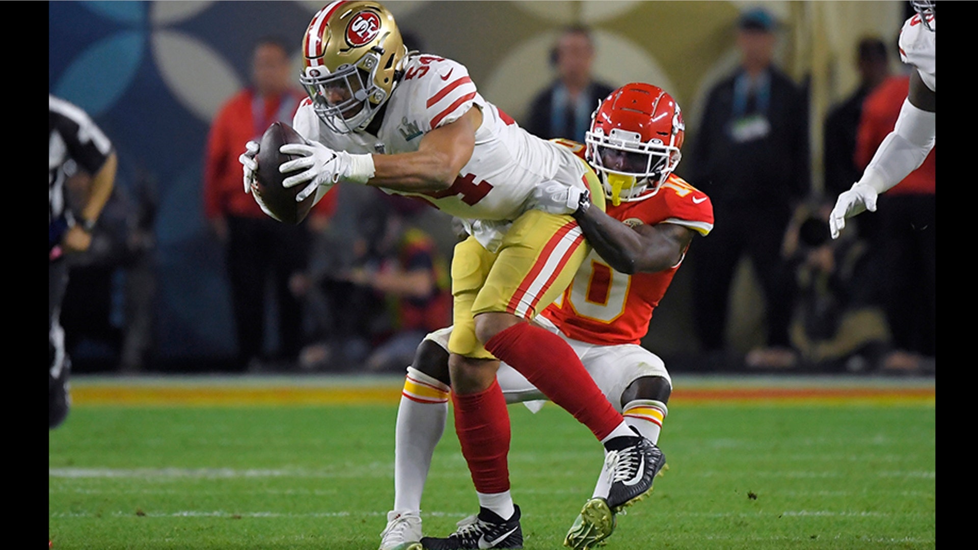San Francisco 49ers' Fred Warner intercepts a pass intended for Kansas City Chiefs' Tyreek Hill, right, during the second half.