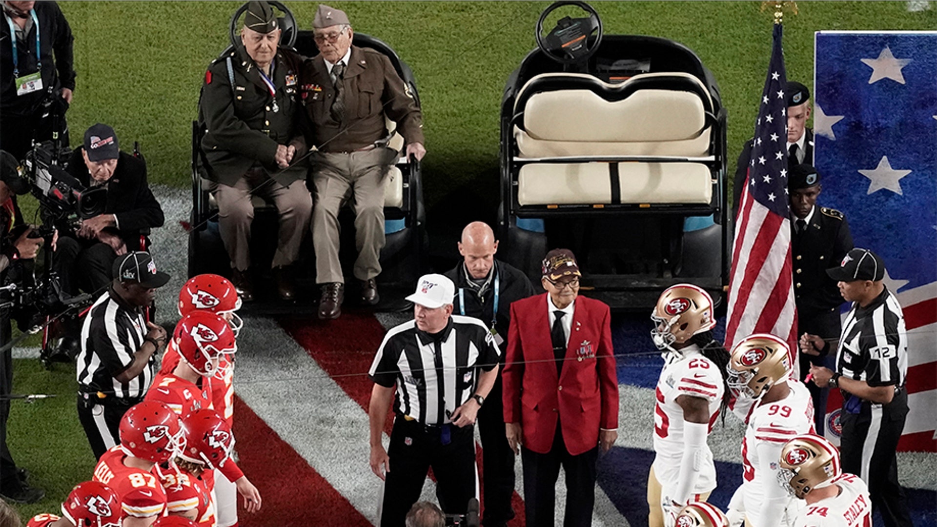 Armed Forces veterans participate during the coin toss.