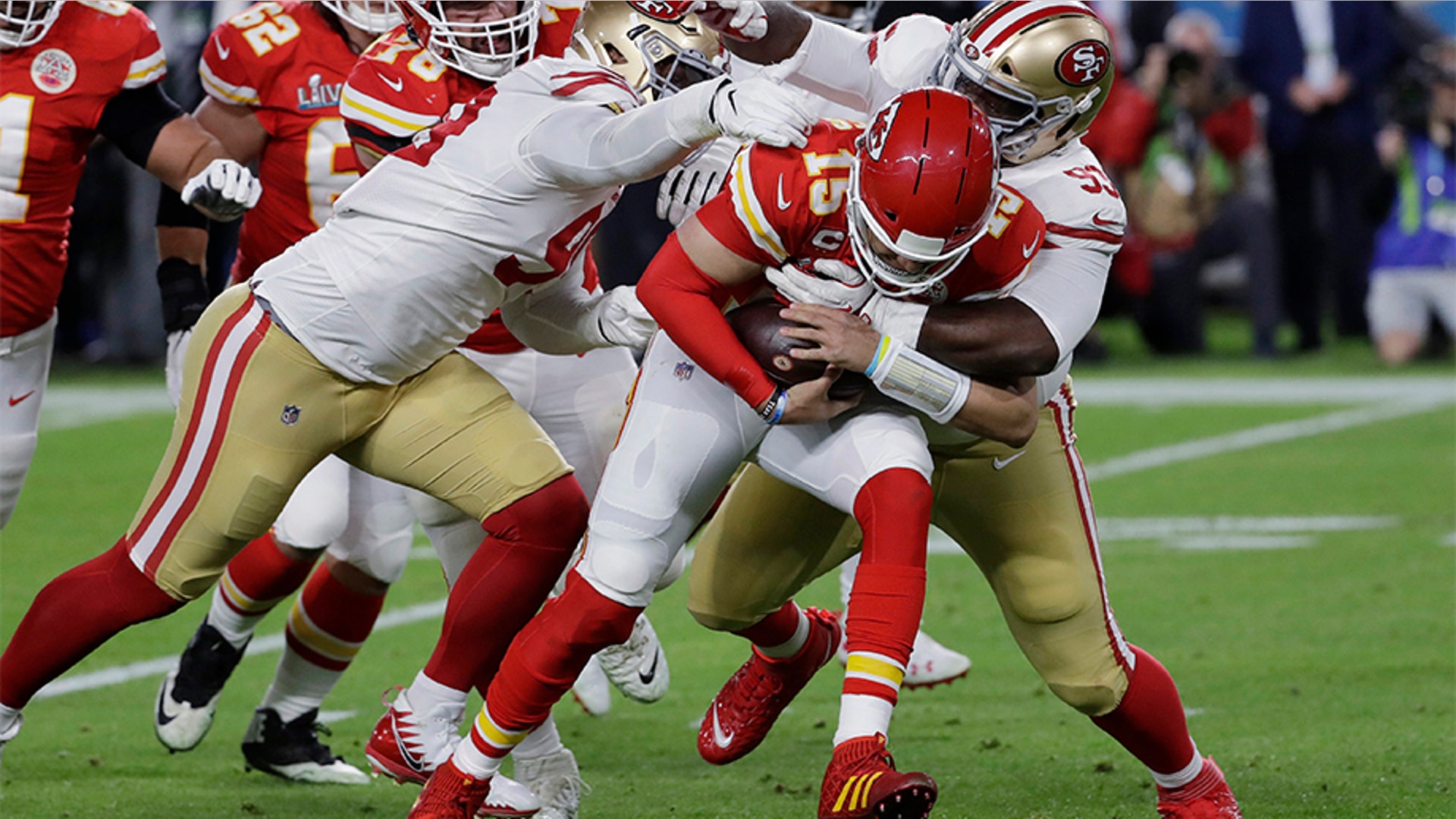 Kansas City Chiefs quarterback Patrick Mahomes (15) runs against San Francisco 49ers' DeForest Buckner, left, and Earl Mitchell during the first half.