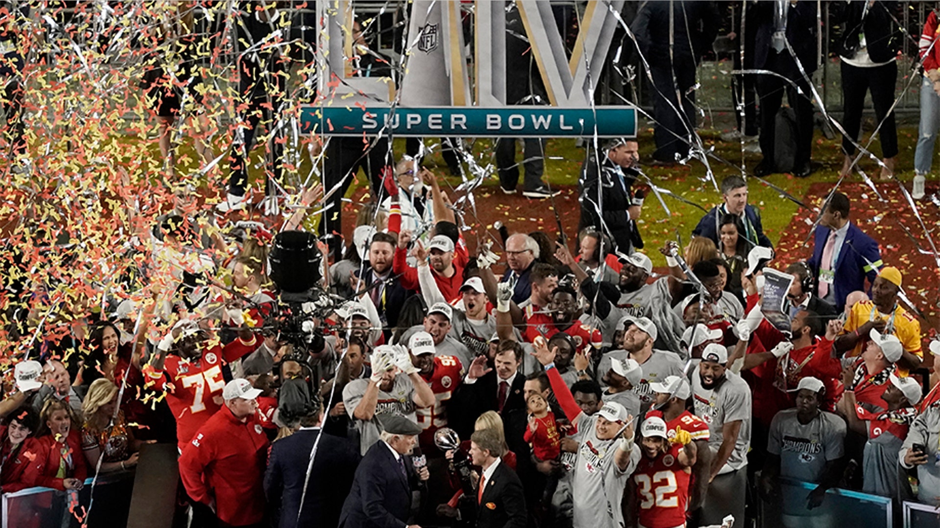 NFL Hall of Fame player Terry Bradshaw congratulates Kansas City Chiefs owner Clark Hunt and Norma Hunt.