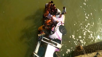 Bus carrying wedding party in India crashes into river, killing at least 24