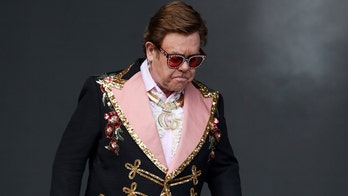 Elton John tearfully escorted off stage after losing his voice mid-concert