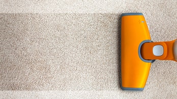 Woman vacuuming sidewalk goes viral -- turns out there's more to the story