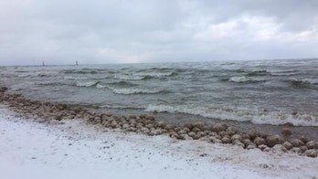 Ice balls appear on Lake Michigan beach, wash up 'by the thousands'