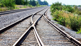 Family taking photos on railroad tracks narrowly escapes train in terrifying video