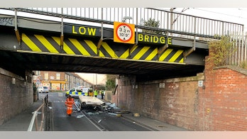 Roof ripped off double-decker bus as it drives under low bridge