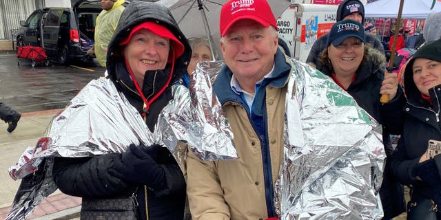 Trump supporters, lining up for post-impeachment rally, predict big 2020 win: ‘He’ll beat them all’ | USNN World News Trump supporter Mike Grunwald and his wife stand outside of the SNHU Arena in Manchester, NH, ahead of the president's re-election rally on the eve of the NH primary, on Feb. 10, 2020