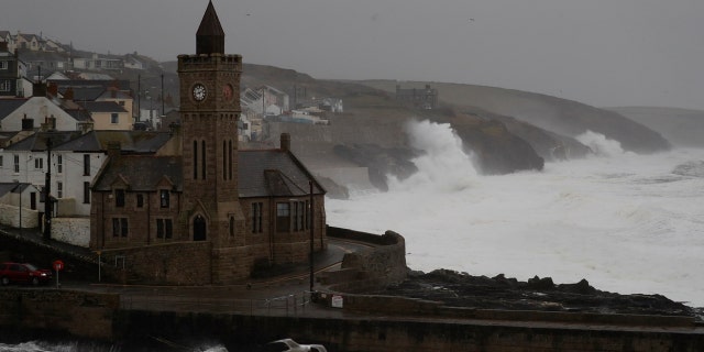 Powerful waves break on the shoreline around the small port of Porthleven, south west England, Sunday, Feb. 16, 2020.