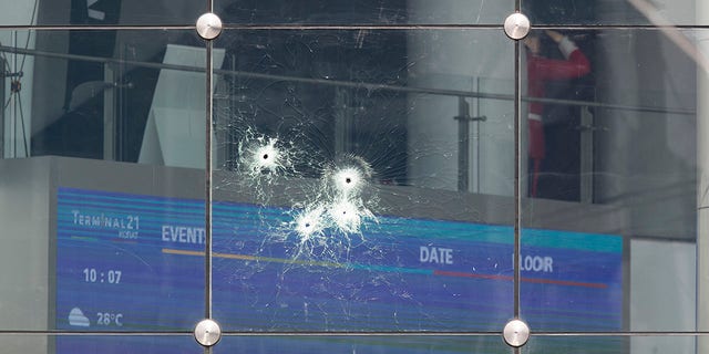 Bullet holes mark the glass wall of the Terminal 21 Korat mall in Nakhon Ratchasima, Thailand, Sunday, Feb. 9, 2020. (Associated Press)