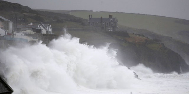 Powerful waves break on the shoreline around the small port of Porthleven, south west England, Sunday, Feb. 16, 2020.