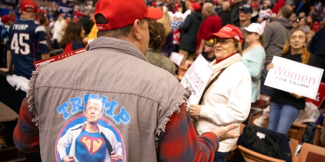 Supporters waiting for the start of President Trump's rally Monday in Manchester, N.H. (AP Photo/Mary Altaffer)